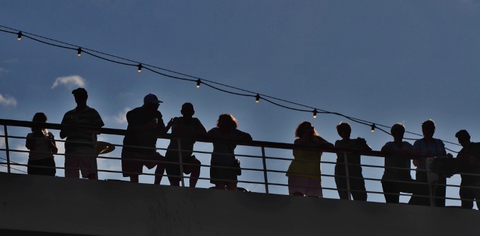sillhouette of ship passengers on deck